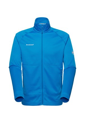 Blue full-zip fleece jacket with high collar, textured horizontal lines, side zip pockets, "Mammut" logo on chest and emblem on left sleeve.