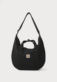 Sac à épaule en tissu noir avec poignées doubles, bandoulière réglable, forme arrondie et un patch logo carré proéminent arborant une icône orange.