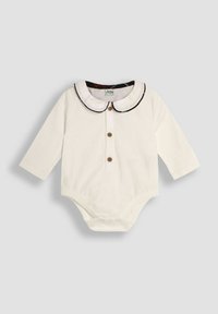 Biała bodysuit z długim rękawem, z okrągłym kołnierzykiem ozdobionym czarnym wykończeniem, z zapięciem na guziki z przodu oraz napami na dole. Miękki materiał.