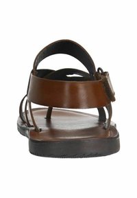 Brown leather sandals with a flat sole, open toe, and multiple crisscross straps. Features an adjustable ankle strap for secure fitting.