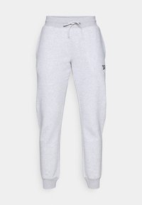 Pantalones de chándal grises hechos de un tejido suave con una cintura elástica, cordón y puños acanalados. Presenta un pequeño logo negro en el lado izquierdo.