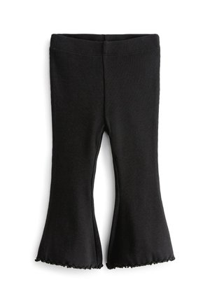 Leggings noir côtelés évasés avec une taille élastique et un ourlet à volants. Texture douce, conçue pour le confort et la liberté de mouvement.