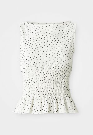 Haut sans manches blanc avec une surface texturée, orné de pois noirs et d'un ourlet volanté. Le design comprend un corsage froncé.