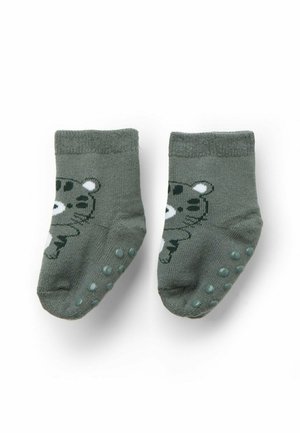 Une paire de chaussettes pour bébés grises avec des semelles antidérapantes et des visages de ours en cartoon à l'avant.