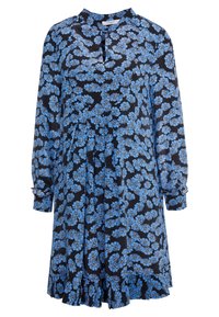Kukallinen mekko tummansinisellä taustalla, jossa on sinisiä kukkia ja keltaisia yksityiskohtia. Pitkät hihat, kaulus ja röyhelöhelma.