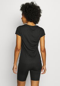 Black short-sleeve athletic top with a round neckline and a relaxed fit, made from a lightweight, breathable fabric.
