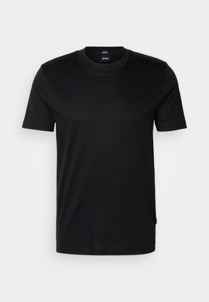 T-shirt nero a maniche corte realizzato in tessuto morbido. Presenta un collo rotondo e un'etichetta discreta sull'orlo. Design semplice senza decorazioni.