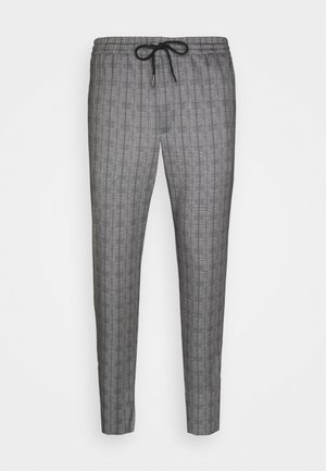 Pantalons à carreaux gris avec une coupe fuselée, taille élastique et cordon de serrage ajustable. Fabriqués en tissu texturé avec un motif en grille subtil.