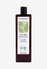 Mörkbrun plastflaska med ett svart flip-lock. Främre etikett har gröna botaniska grafik och text som anger tea tree-duschgel, 500 ml.