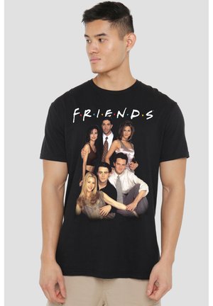 Man wearing black t-shirt with the cast of the TV show Friends posing and the word FRIENDS above them in stylized letters.