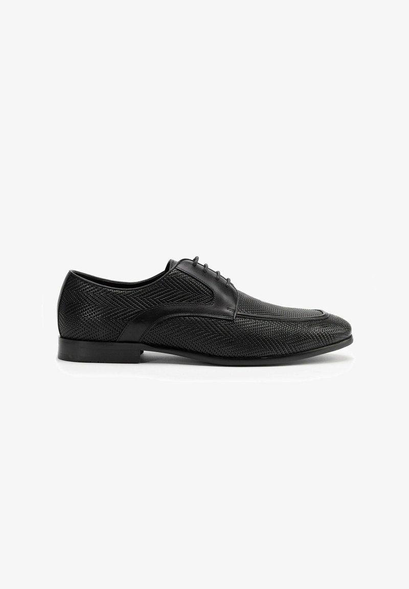 Zwarte dress schoen met een gestructureerd mesh-design, gladde leren accenten, een puntige neus en dunne veters op een platte zool.