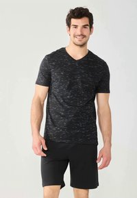 Black short-sleeve v-neck t-shirt with a textured pattern of subtle gray streaks, paired with black shorts. Soft fabric, casual fit.