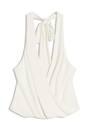 Ærmeløs hvid haltertop med dyb V-udskæring både foran og bagpå, med stofbindelukning ved nakken.