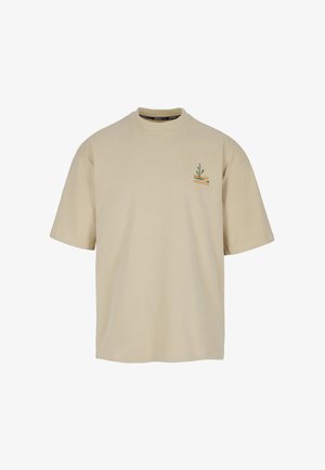 Beige short-sleeve t-shirt with small green cactus and orange graphic on upper left chest.