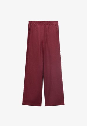 Burgundské široké kalhoty vyrobené z měkké tkaniny, se pružným pasem, dvěma bočními kapsami a uvolněným střihem.