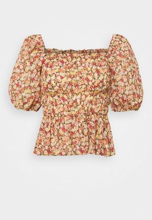 Bloes met bloemenprint en poffende mouwen, elastische bovenkant en peplumzoom. Heeft een lichte, gestructureerde stof met een mix van roze, gele en groene bloemen.