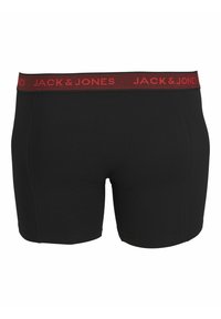 Černé boxerky vyrobené z měkké látky, s červeným elastickým pasem, na kterém je kolem dokola vytištěno jméno značky "JACK & JONES".