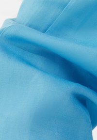 Light blue fabric, smooth texture, folded with fine weave pattern. Contains no visible design accents or additional details.