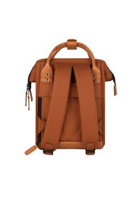 Brown backpack with padded straps, two top handles, and zip closures. Features external pockets and a smooth, textured surface.