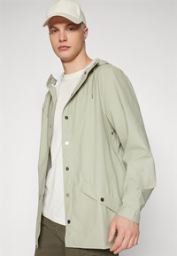 Rains JACKET UNISEX - Parka - earth