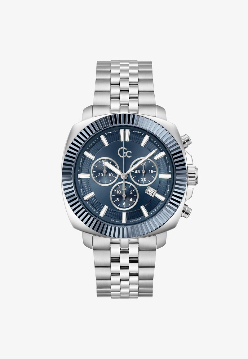 Sølvfarvet ur i rustfrit stål med blå urskive, prikket ramme, tre underskiver og datovindue. Har et sammenkædet metalarmbånd.