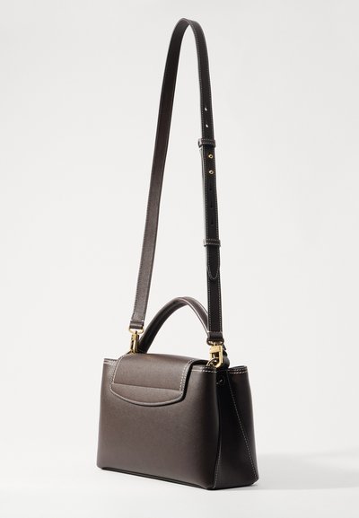 Brown leather handbag with a structured shape, contrast stitching, and a detachable strap. Features a top handle and gold-tone hardware.