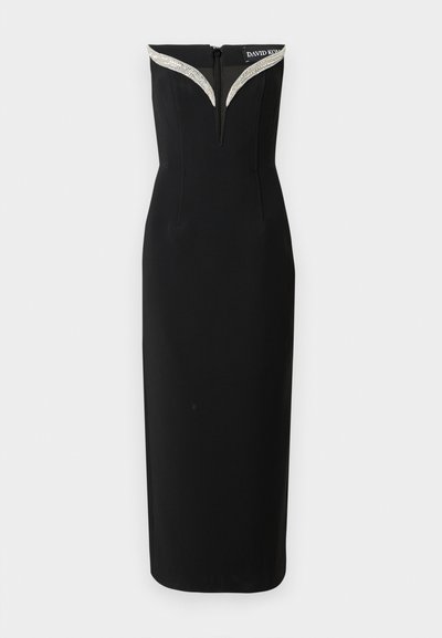 Μαύρο εφαρμοστό φόρεμα με κομψή γραμμή, που διαθέτει V-γραμμή λαιμόκοψη διακοσμημένη με ασημένιες λεπτομέρειες και κρυφό φερμουάρ στο πίσω μέρος.