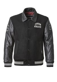 Schwarze College-Jacke mit einem Wollkörper und Lederärmeln. Enthält gestickten Text, gestreifte Bündchen und Reißverschlusstaschen. Nummerierte Aufnäher auf den Ärmeln.