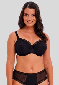 Black bra with underwire, vertical striped texture, lace trim along the edges, and a gold accent in the center. Matching high-waist underwear.