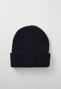 Granatowa dziana czapka z prążkowanym wzorem i podwiniętym brzegiem, z bezszwowym wierzchem i miękkim, elastycznym materiałem.