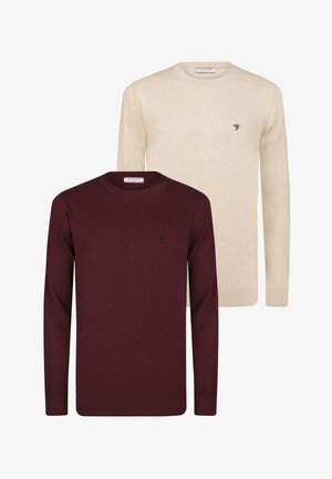 To langærmede crewneck-trøjer, en beige og en mørk bordeaux, hver med et lille fuglelogo på venstre bryst.