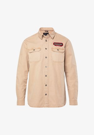 Beżowa koszula na guziki wykonana z bawełny, z dwoma kieszeniami na piersi, naszywką z napisem "INDUSTRY" oraz metalowymi guzikami. Długie rękawy.