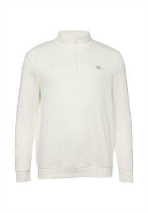 Biały pulower z długim rękawem, z suwakiem sięgającym do ćwiartki długości oraz małą, prostokątną naszywką z logo na lewej piersi.