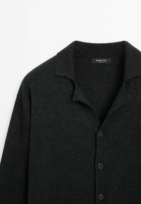 Cardigan en tricot gris foncé avec boutons et col doux, étiqueté Massimo Dutti, présenté sur fond blanc.