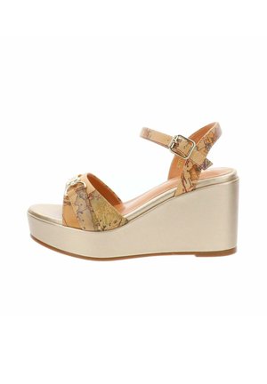 Sandale compensée avec semelle plateforme beige, brides à motif carte et fermeture à boucle dorée sur la bride de cheville.