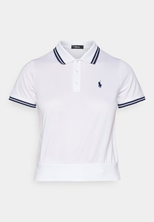 White polo shirt made of cotton, featuring navy stripes on the collar and sleeves, with a small navy logo on the left chest. Short sleeves.