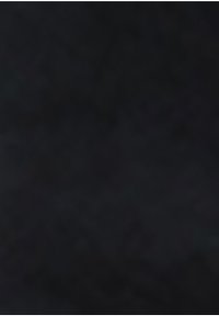 Surface noire à texture rugueuse avec des variations subtiles de tons foncés et des taches de lumière clairsemées et faibles.