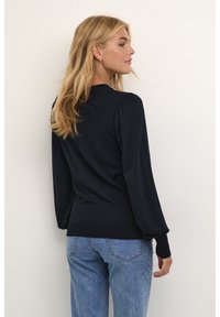 Navy sweater with long, puffed sleeves and a fitted hem. Made of soft knit material, features ribbed cuffs and a rounded neckline.