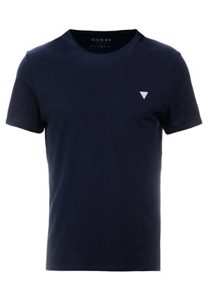 T-shirt en coton bleu marine avec un col rond, des manches courtes et un petit logo triangulaire blanc sur le côté gauche de la poitrine. Texture lisse.