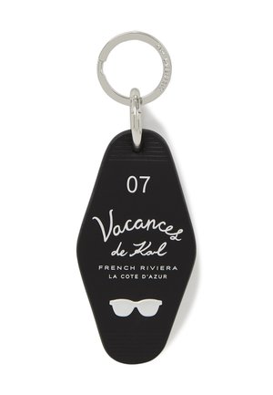 Black keychain with silver ring, number "07," "Vacances de Kol," "French Riviera La Cote d'Azur," and white sunglasses icon.