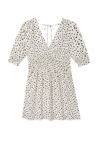 Kleid mit Polka-Dots in Creme mit schwarzen Punkten, ausgestattet mit einem tiefen V-Ausschnitt, elastischem Taillenbund und Puffärmel. Leichter Stoff mit einer Krawattenverschluss im Rücken.