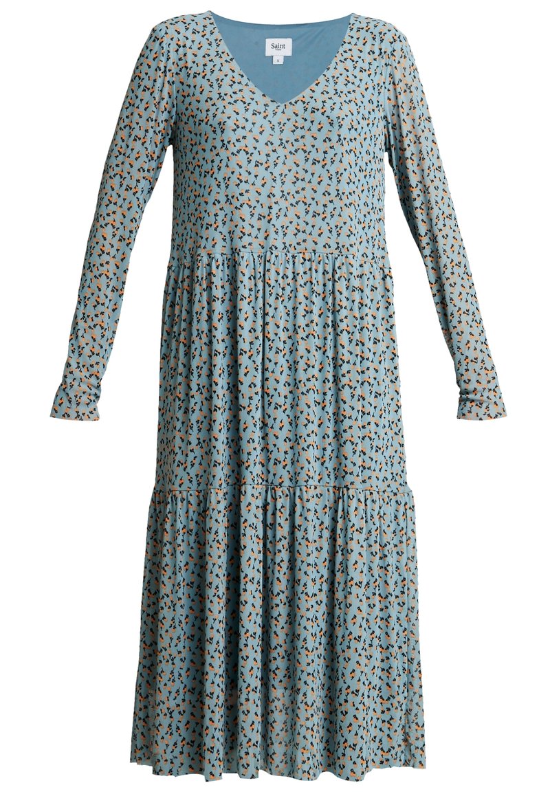 Sukienka z długim rękawem i dekoltem w kształcie litery V w jasnoniebieskim materiale z kwiatowym wzorem w kolorze czarnym i brązowym. Posiada warstwowy krój i luźny fason.