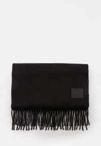 Črn volnen šal z resicami na koncih in majhno pravokotno nalepko prišitno v enem kotu. Mehek na dotik, pravokotne oblike.