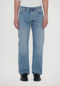 Light blue denim jeans with a straight-leg cut, five-pocket design, and medium-rise waist. Reinforced stitching and metal hardware details.
