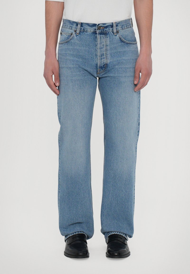 Light blue denim jeans with a straight-leg cut, five-pocket design, and medium-rise waist. Reinforced stitching and metal hardware details.