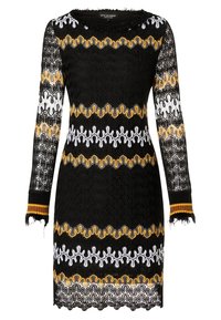 Svart klänning med långa ärmar, prydd med texturerade mönster i vitt och gult. Fransad fåll och randiga manschetter i svart och gula accenter.
