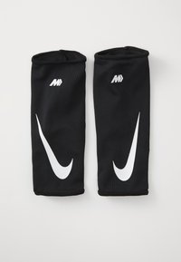 Must mustristid mustree M brändiga valge Nike sisselogo. Sile tekstuur, sobiv disain suurenenud toe jaoks tegevuste ajal.