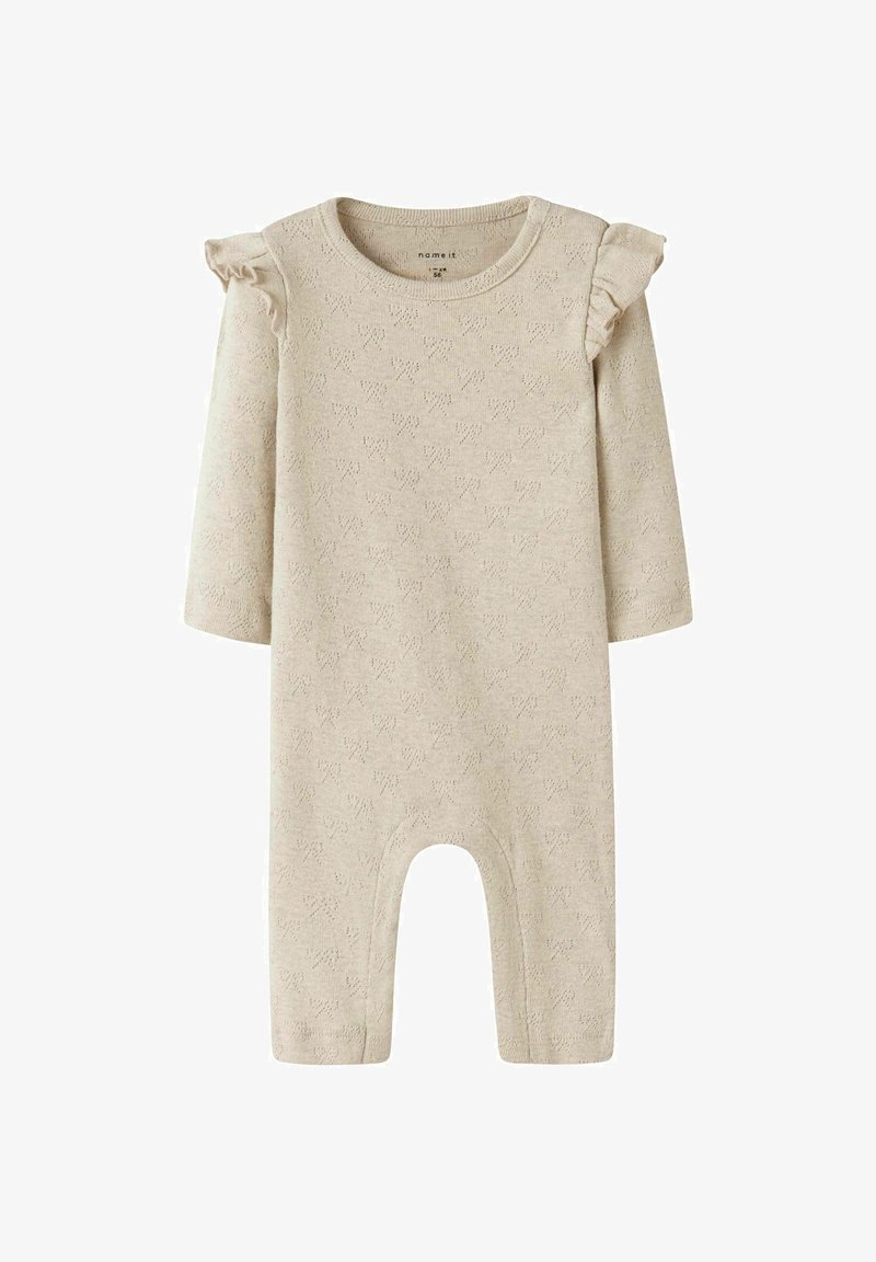 Beige kudumojak, millel on pikad varrukad, volangidega õlavarrekaunistused ja tekstuuriline mustri. Omab avatud põhja, mis võimaldab kergesti selga panna.