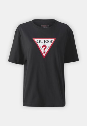 Črna bombažna majica s kratkimi rokavi, ki ima rdeč in bel trikotni logotip z napisom "GUESS U.S.A." in vprašajem v sredini. Okrugel izrez.