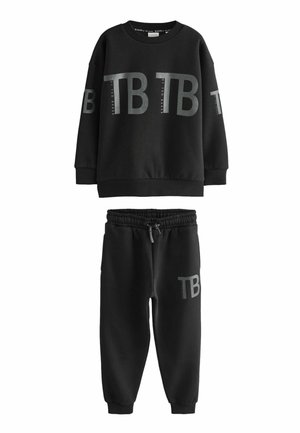 Ensemble sweat à capuche et jogging en matériau doux. Le sweat à capuche arbore un grand logo "TB", tandis que le jogging possède une taille élastique et un logo similaire.